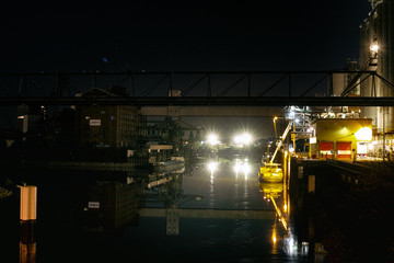 Oil refinery with water vapor in Mannheim, Germany, petrochemical industry night scene