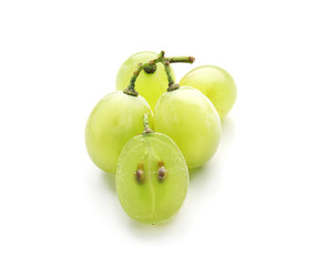 Cut and whole ripe juicy grapes with seeds on white background