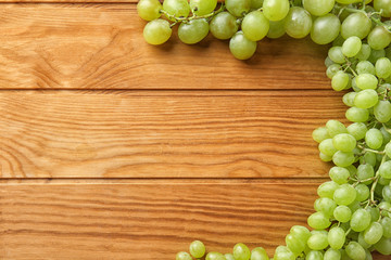 Ripe sweet grapes on wooden background