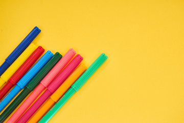 Fototapeta premium colorful pens on yellow background