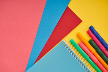 office equipments with colorful papers on yellow background