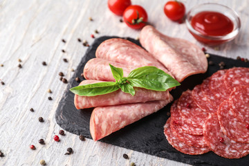 Slate plate with different kinds of sausages on light table