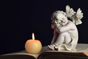 Memorial candle and angel figurine