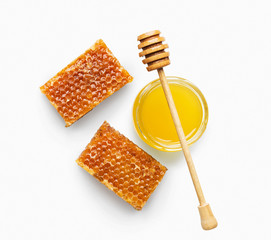 Jar full of fresh honey and honeycombs isolated on white