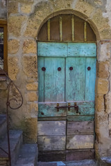 Old light blue wooden door with steps