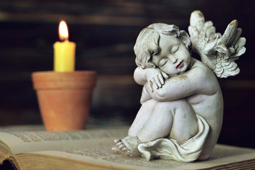 Sleeping angel and burning candle