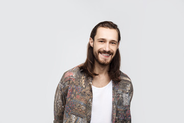 Obraz premium Picture of stylish trendy-looking young man of European appearance, demonstrating his perfect white teeth. Youth and happiness, flirty emotion, freestyle, lifestyle concept, hipsteer style
