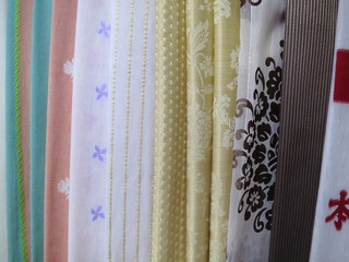 Buying fabrics with different patterns. Fabrics with patterns and colors. 