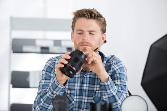 man inspecting the camera lens