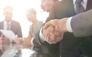 handshake of business partners in conference room