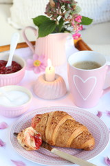 breakfast with coffee and croissant on porcelain in pink