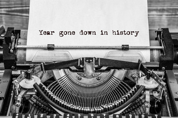 year gone down in history, text on a vintage typewriter, in black ink on old paper.