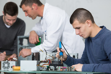 repairman soldering electronic components on cpu
