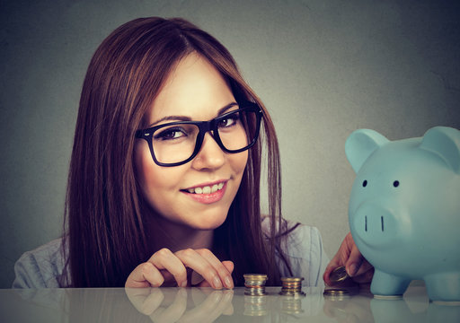 Charming woman with coins and piggy bank