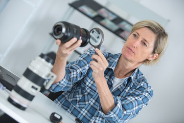 female photographer adjusting a camera