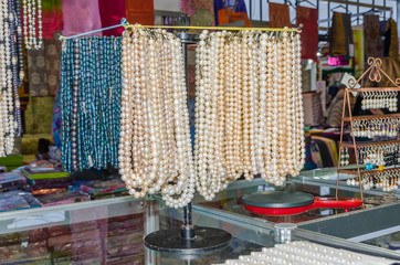 women's beads and necklace hanging in the exhibition