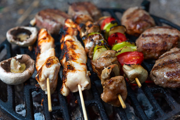 Barbecue grill outdoor, close up.  Various meat marinated grilling. Selective focus.