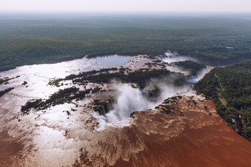 Top view of the Iguazu waterfalls, parana river and huge rainforest spaces.