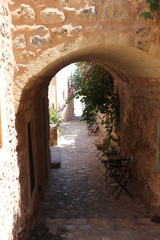 Old arch on narrow medieval street of Monemvasia, Peloponnese, Greece