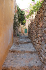 Fototapeta na wymiar Cozy narrow street in old town Monemvasia, Peloponnese, Greece