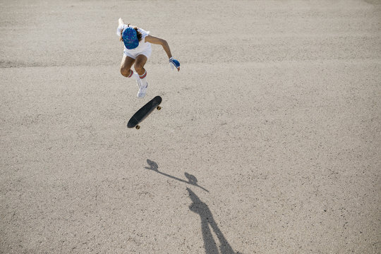 From above shot of sportive man riding skateboard