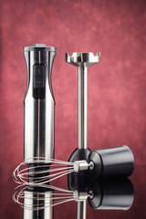 Blender with accessory on the red mirror background