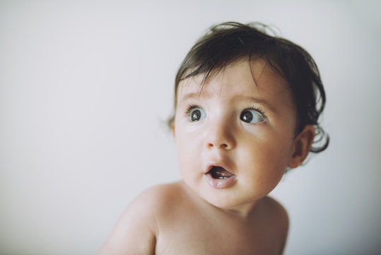 Surprised baby girl on white background