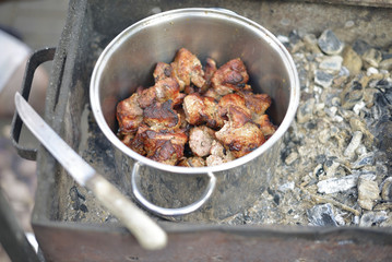 Fire-roasted chunks of pork are in the pot