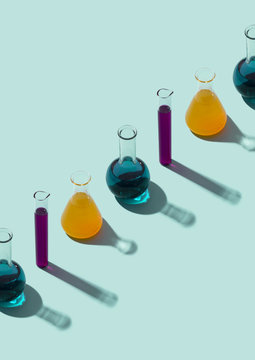 Row of test tubes with liquid, cyan background