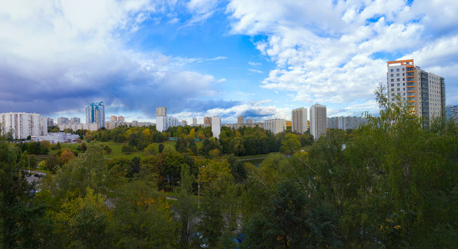 Panorama residential disctrict of Moscow with beautiful clouds in the blue sky, soviet houses, a large park &ndash; panoramic view of the city in high resolution, early autumn