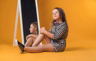 the child in the Studio posing in fashionable clothes