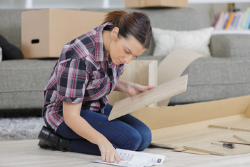 frustrated woman with self assembly furniture in kitchen