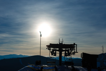 Panoramic view of sport resort for winter vacation - Skies with back light - Warm filter with original sun color tones