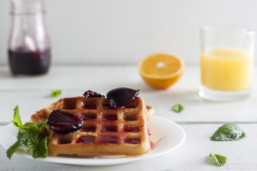 Viennese, Belgian waffles with honey on a white plate.