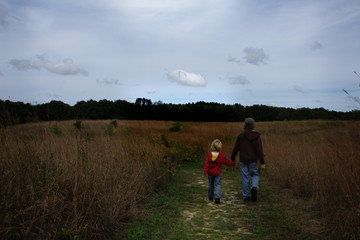 Two Young School Aged Blond Boys Walking Away on a Trail Through a Prairie Restoration