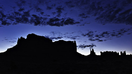 Silhouettes of mountains on a desert at dawn