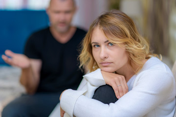 Obraz premium Family problems of the young wife and husband on the sofa in a room.