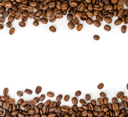 Coffee beans are laid out on top and bottom of the frame on a white.