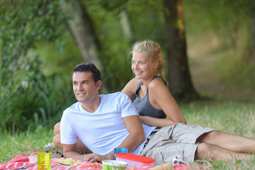 young couple laying on grass