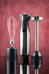 Blender with accessory on the red mirror background