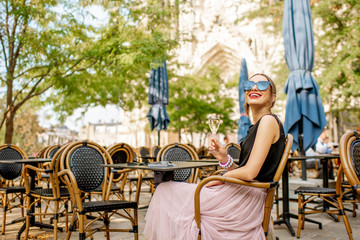 Woman with a glass of champagne in Reims, France - obrazy, fototapety, plakaty