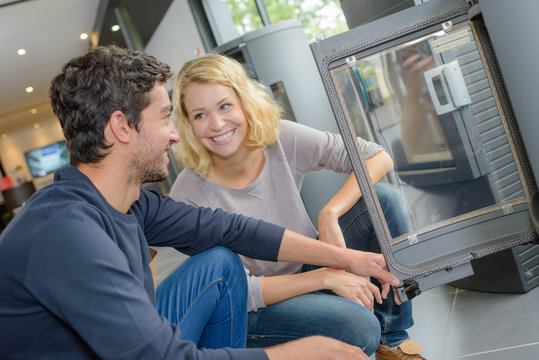 Young couple looking at wood burners