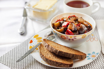 Vegetable sauté with eggplant, red pepper and tomatoes, and toasted rye bread