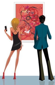 Rear view of a couple looking at a painting