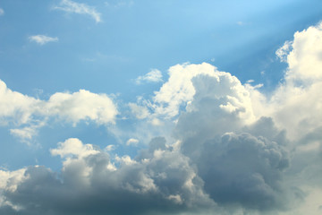Large lush clouds and sunrays. Background. Landscape.