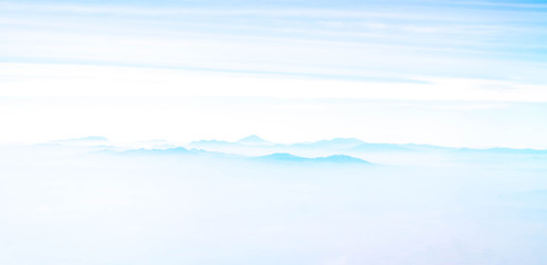 mountains among the cloud. panorama of mountain peaks covered by cloud. nature background