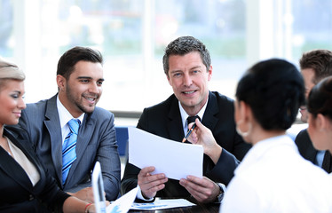 businessman and his business team discussing working papers.