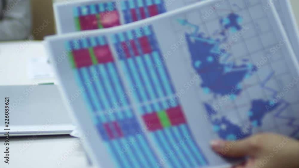 Poster close up hands of unrecognizable entrepreneur looking through documents with graphs and charts at me
