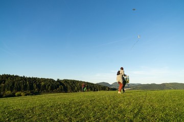 People playing with kite on meadow. Slovakia	