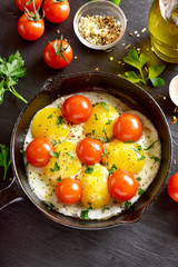 Fried eggs with tomatoes